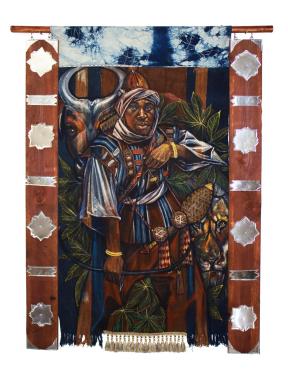 A mixed media, hanging artwork of two wooden panels adorned with metallic shapes flanking dyed cloth. The main image of the cloth is a man, Sundiata Keita, surrounded by plants, an ox, and a lion. 