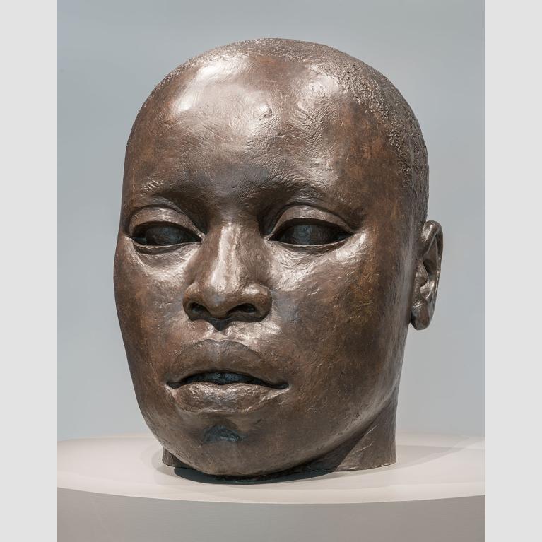 Sculpture of bronze head with African-American features and closely cropped hair