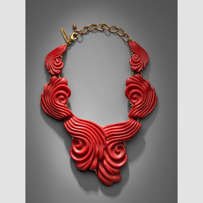 A bright-red swirly coral resin necklace. 
