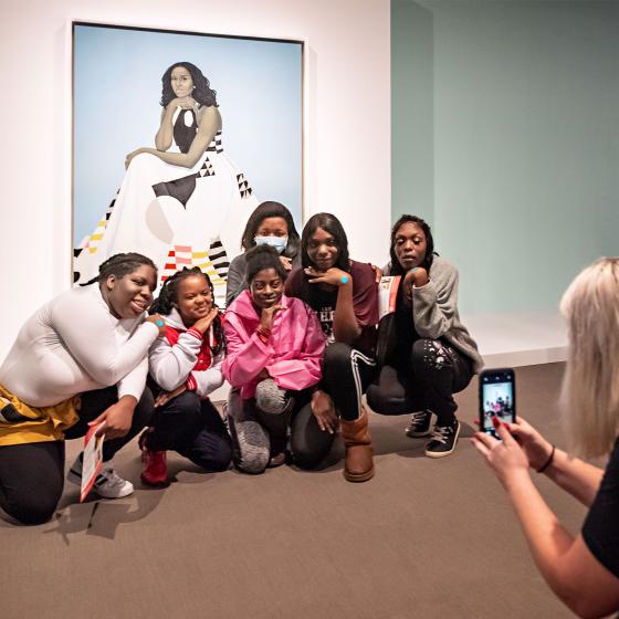 Visitors pose for a photo in front of Michelle Obama's portrait for the National Gallery