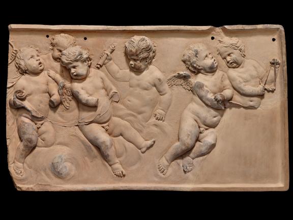 A terracotta relief of six angels playing various instruments. 