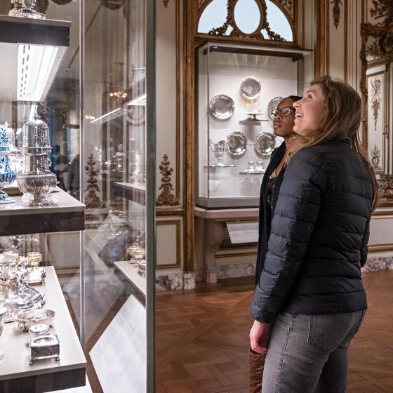 Two visitors explore the French Salon gallery.