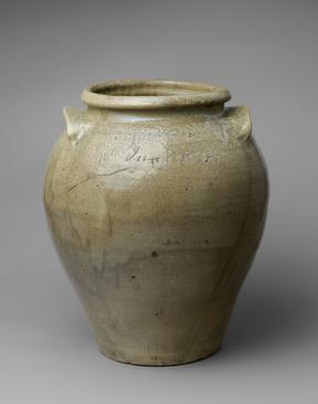 A large, greenish clay jug with a large opening, two handles, and imprinted with the test "12th June 1834."