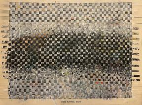 Paper painted and woven to make a grid with a dark center. 