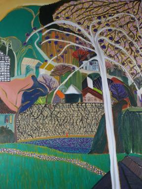 A small town on a hill with a bare, white tree in the foreground