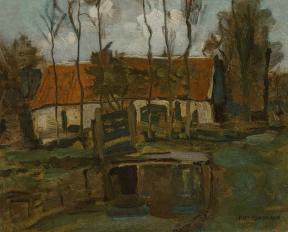 A white farm building with a red roof sits in a field dotted by trees. 