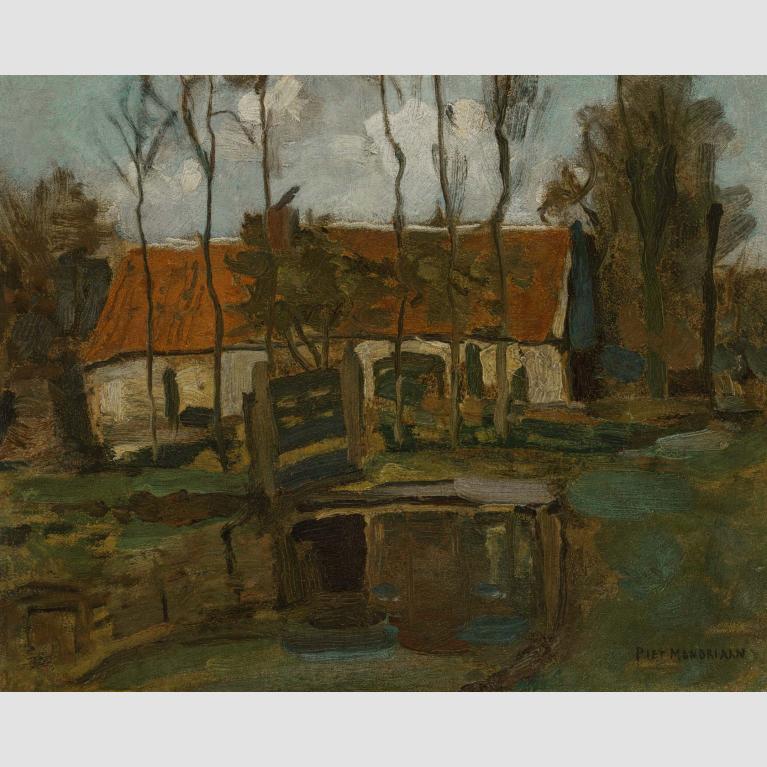 A white farm building with a red roof sits in a field dotted by trees. 