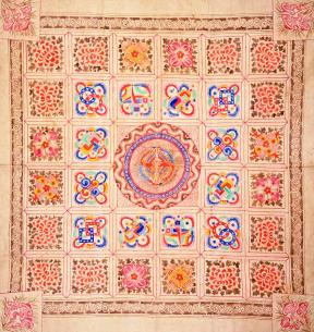 A square hemp wrapping cloth with a multi-colored painted design.