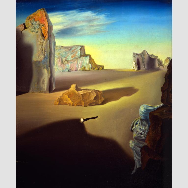 A landscape of large jagged boulders sitting in a sandy desert. 