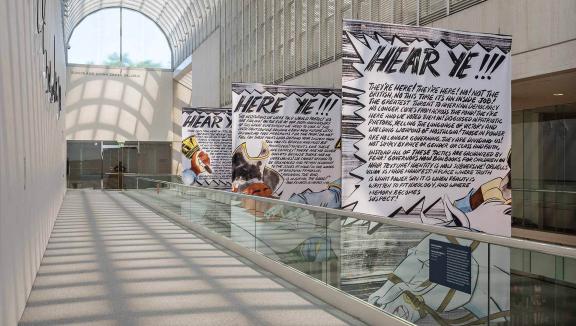 A sunlit hallway with large banners hanging from the rafters.