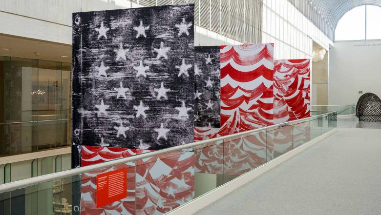 An abstracted American flag with crooked stripes and roughened stars.