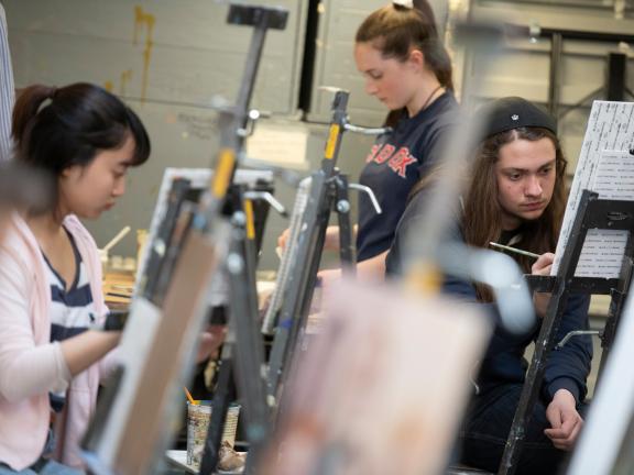 teen students painting at easels in studio art classroom (SAC)