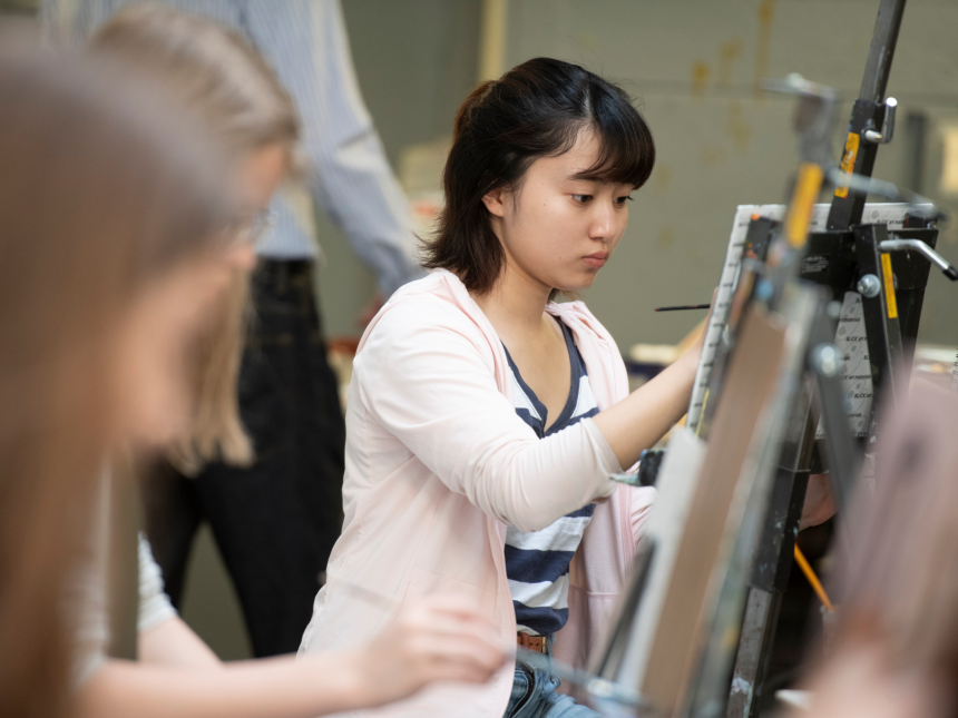 student painting at easel