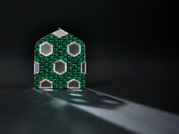 Small, green brooch with white, hexagonal gemstones